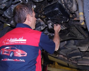 Auto mechanic working on a European car repair at the foreign aid